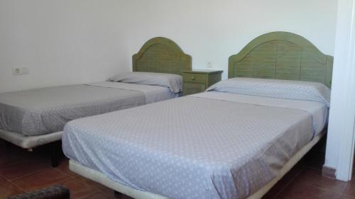 two beds in a room with two at Ático Playa in Cartagena