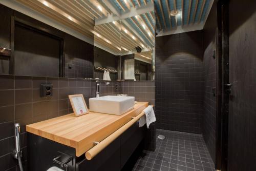 a bathroom with a white sink and a counter at Hotel Vartiosaari The Aurora Island in Rovaniemi