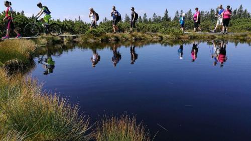 a group of people riding bikes around a body of water at APARTMA ARNIKA Rogla, Turistično naselje NUNE RESNIK, RESNIK 110 in Zreče