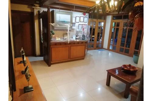 a large kitchen with a counter and a table at RedDoorz at Casa Marabella Villamonte Bacolod City in Bacolod