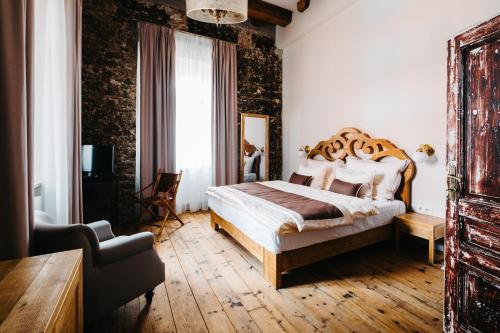 a bedroom with a large bed in a room at Boutique hotel Corso in Řevnice