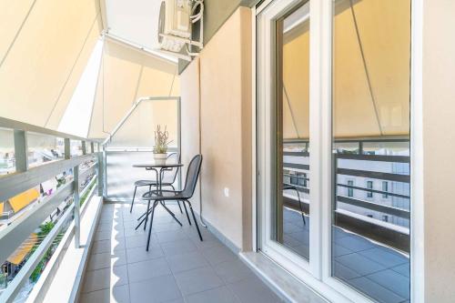 un balcón con mesa y sillas. en Suites 05-06 - Smart Cozy Suites - Large 2 bedroom, near Athens and metro, en Atenas