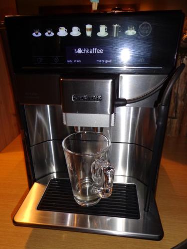 a coffee maker with a glass on a rack at Pension Schamberger in Neukirchen beim Heiligen Blut