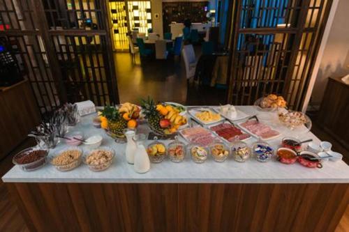 a table with many different types of food on it at Hotel Boavista in Timişoara