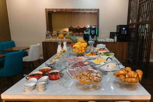 a buffet of food on a table in a room at Hotel Boavista in Timişoara