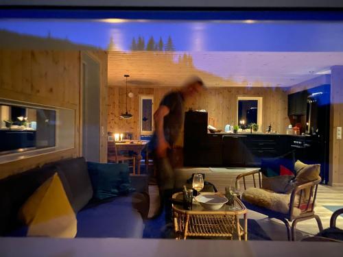 a man is standing in a living room at Tuddal Hyttegrend HYTTA KÅNS in Hjartdal