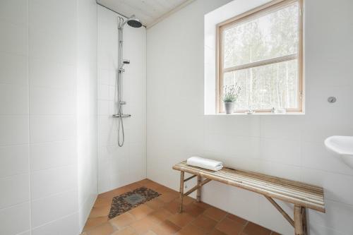 a white bathroom with a sink and a window at STF Tåtorp Cafe & Logi Göta Kanal in Tåtorp