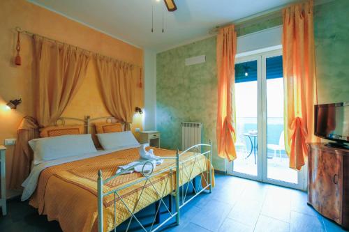 a bedroom with a large bed and a sliding glass door at Villamir B&B in Albenga