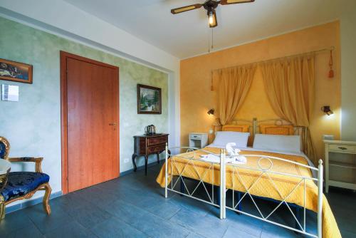 a bedroom with a bed and a table and a window at Villamir B&B in Albenga