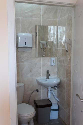 a bathroom with a toilet and a sink at Хостел на Баварии in Kharkiv