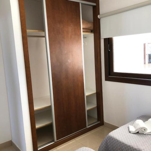 a closet with a wooden door in a bedroom at Cotillo Ocean View in Cotillo
