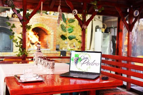 a laptop computer sitting on a red bench on a table at Casa Pedro in Blăjani