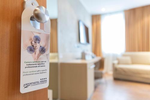 a sign on the door of a room at Airporthotel Verona Congress & Relax in Dossobuono
