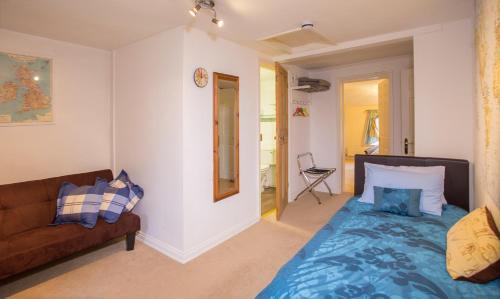 a living room with a bed and a couch at The Old Rectory Chicklade in Chicklade