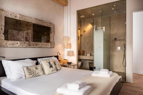 a bedroom with a bed with two towels on it at Glaros Luxury Villa in Kato Daratso