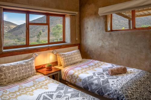 Un ou plusieurs lits dans un hébergement de l'établissement Kingfisher Cottages, Langhoogte Farm