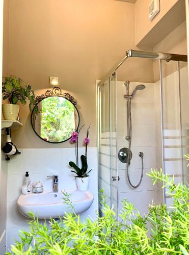 a bathroom with a sink and a shower with a mirror at Casa Italia in Verona