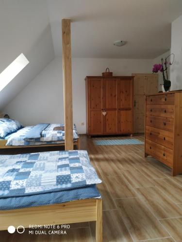 a bedroom with two bunk beds and a dresser at Ubytovani Ve stodole in Stráž nad Nežárkou