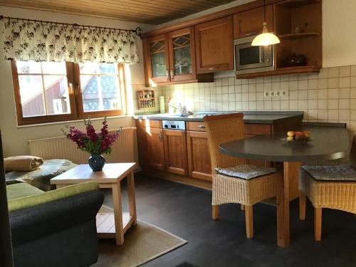 a kitchen with a table and chairs and a dining room at Ferienwohnung Schulze Jonsdorf in Kurort Jonsdorf