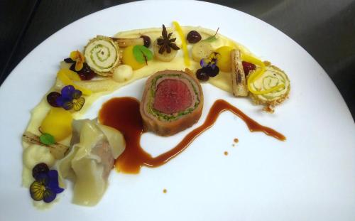 a white plate with food on top at Romantik Alpenhotel Waxenstein in Grainau