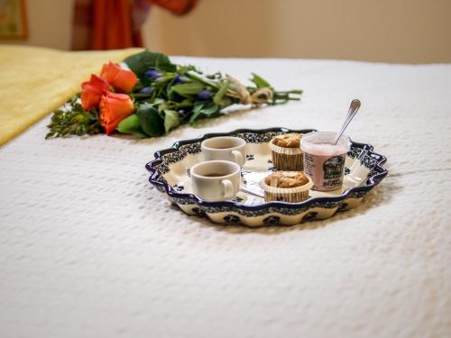 a tray with cups and muffins on a table at Residence Pedranzini in Bormio