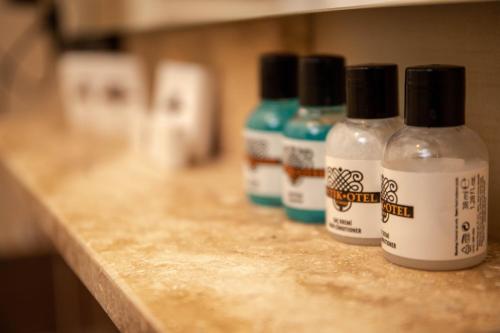 three bottles of glue sitting on top of a counter at Sinop Antik Otel in Sinop