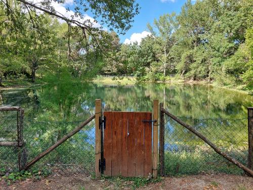 an open gate in front of a lake at Chiosi Country Club in Corleone