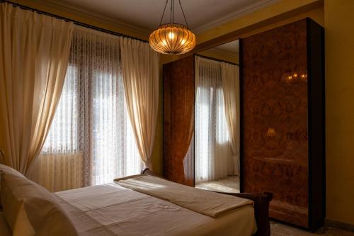 a bedroom with a bed and a large mirror at Casa Josephine in Taormina
