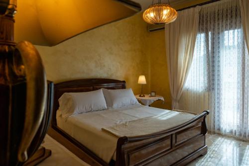 a bedroom with a bed in a room with windows at Casa Josephine in Taormina