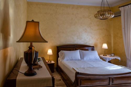 a bedroom with a bed and a lamp on a table at Casa Josephine in Taormina