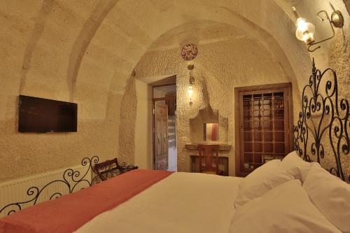 Ένα ή περισσότερα κρεβάτια σε δωμάτιο στο Jacob's Cave Suites - Cappadocia