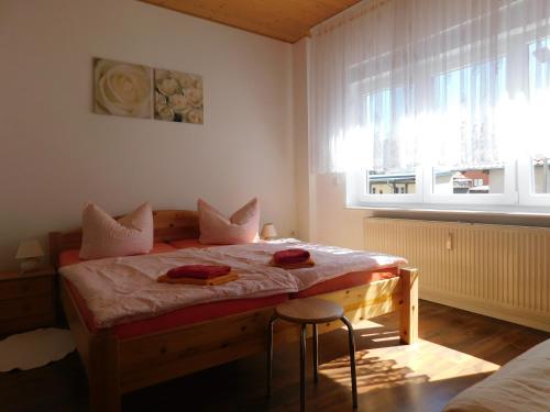 a bedroom with a bed with two towels on it at Ferienwohnung Mack in Wernigerode