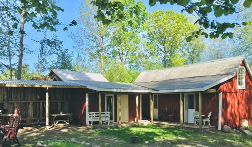 a barn house with a porch and patio at Skrattande Ko in Tingsryd