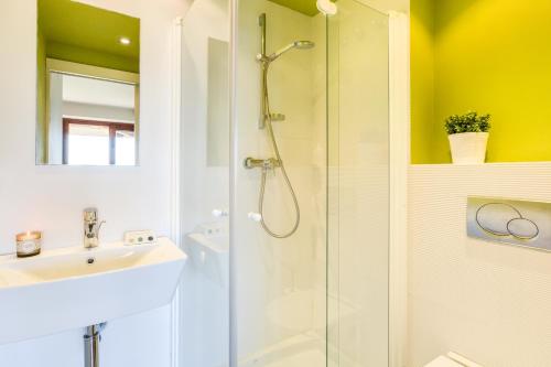 a bathroom with a shower and a sink at Lets Holidays garden house in front of the beach in Tossa de Mar