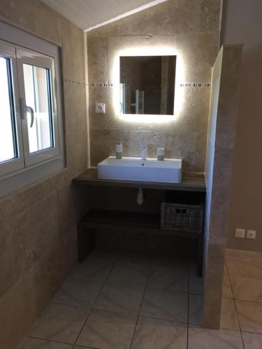 a bathroom with a sink and a mirror at B&B et Gite d'ayran in Saint-Quentin-la-Poterie