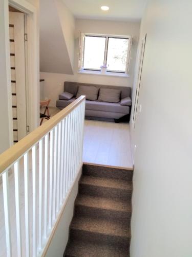 a staircase leading to a living room with a couch at Preila 2 in Preila