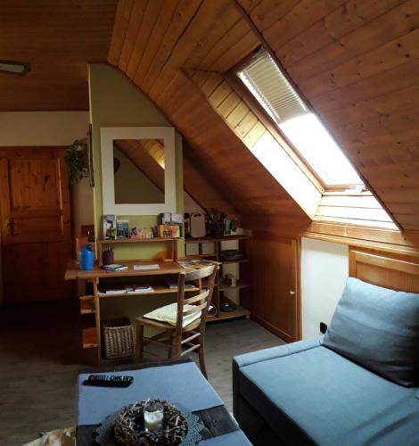 a room with a bed and a desk with a window at Stierstall-Suite Pension Wahlenau in Wahlenau