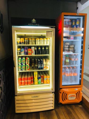 a refrigerator filled with lots of sodas and drinks at Hotel Lirio - Adult Only in Mexico City