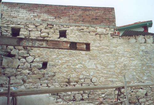 a stone wall with windows on the side of a building at Stou Kir Yianni in Omodos
