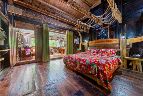 a bedroom with a bed in a room with wooden walls at Forest Glass inn in Zhangjiajie