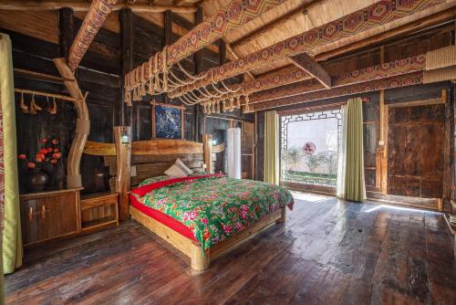 a bedroom with a bed in a wooden room at Forest Glass inn in Zhangjiajie