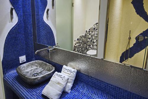 a bathroom with a sink and a mirror at Astarte Suites in Akrotiri