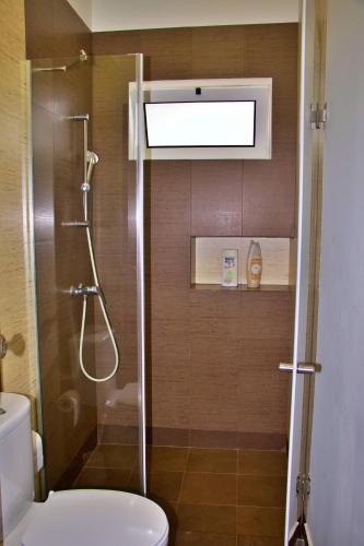 a bathroom with a shower with a toilet and a sink at Quinta Tallinus in Funchal