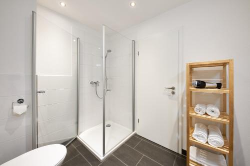 ein Bad mit einer Glasdusche und einem WC in der Unterkunft Ferienwohnung Weißburgunder in Lieser