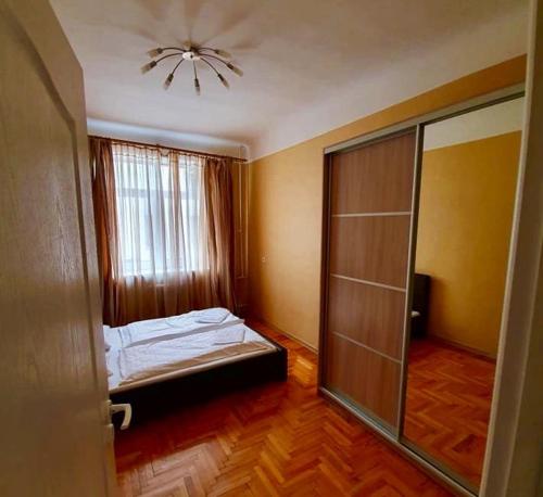 an empty room with a bed and a window at Designapartments in Rīga