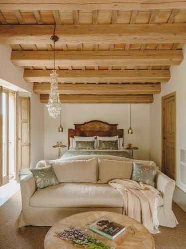 a living room with a couch and a bed at Mas Generós - Adults-Only Eco Hotel in Fonteta