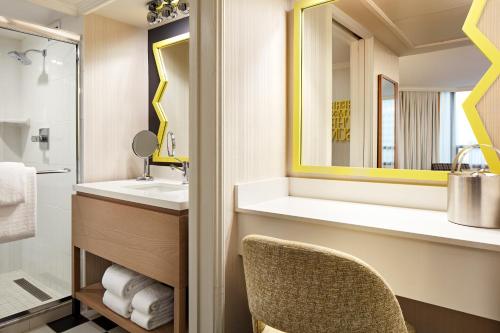 a bathroom with a sink and a mirror at The Bristol Hotel San Diego in San Diego