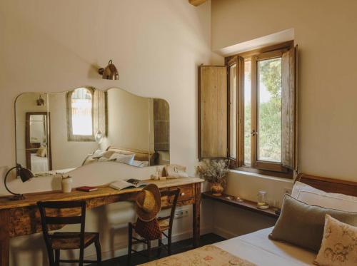 a bathroom with a sink and a vanity with a mirror at Mas Generós - Adults-Only Eco Hotel in Fonteta