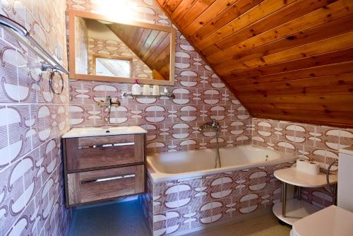 a bathroom with a sink and a bath tub at Pension Dymník in Rumburk