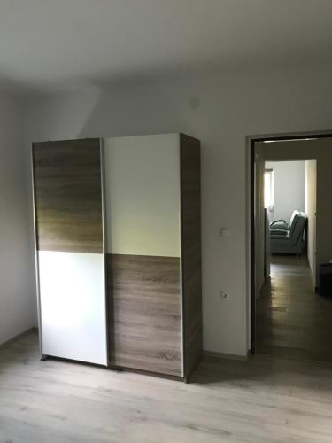 a room with two sliding doors and a room with a couch at Apartments Lena in Baška